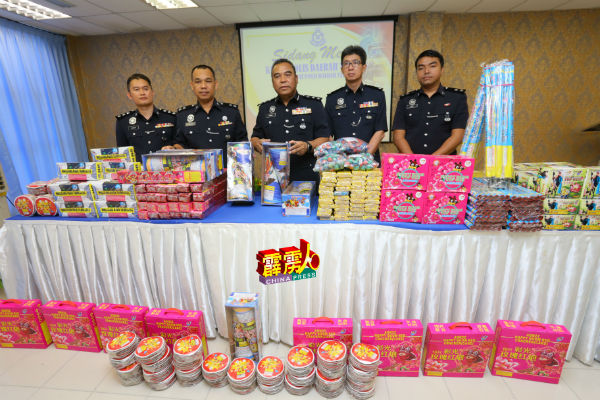 奥斯曼马末（中）与查案警官，展示起获的鞭炮烟花。