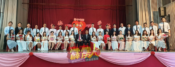 19对新人与吴业成(坐者右11起)及黄保生合影。