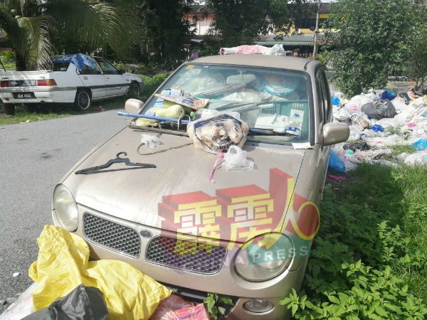 铁门外停放的1辆国产灵鹿轿车,同样也成了置放回收物的“储藏间”。