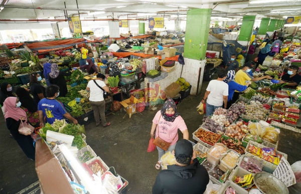 怡保中央公市售卖蔬菜类和杂货摊位，也见市民购买蔬菜和各类香料。