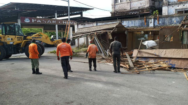 市政厅出动铲泥机和职员拆除有关建筑物，过程顺利。