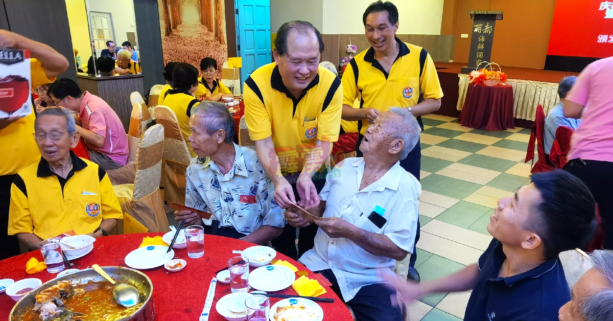 陈利进（站者右2）派发感恩红包给70岁以上的年长会员。
