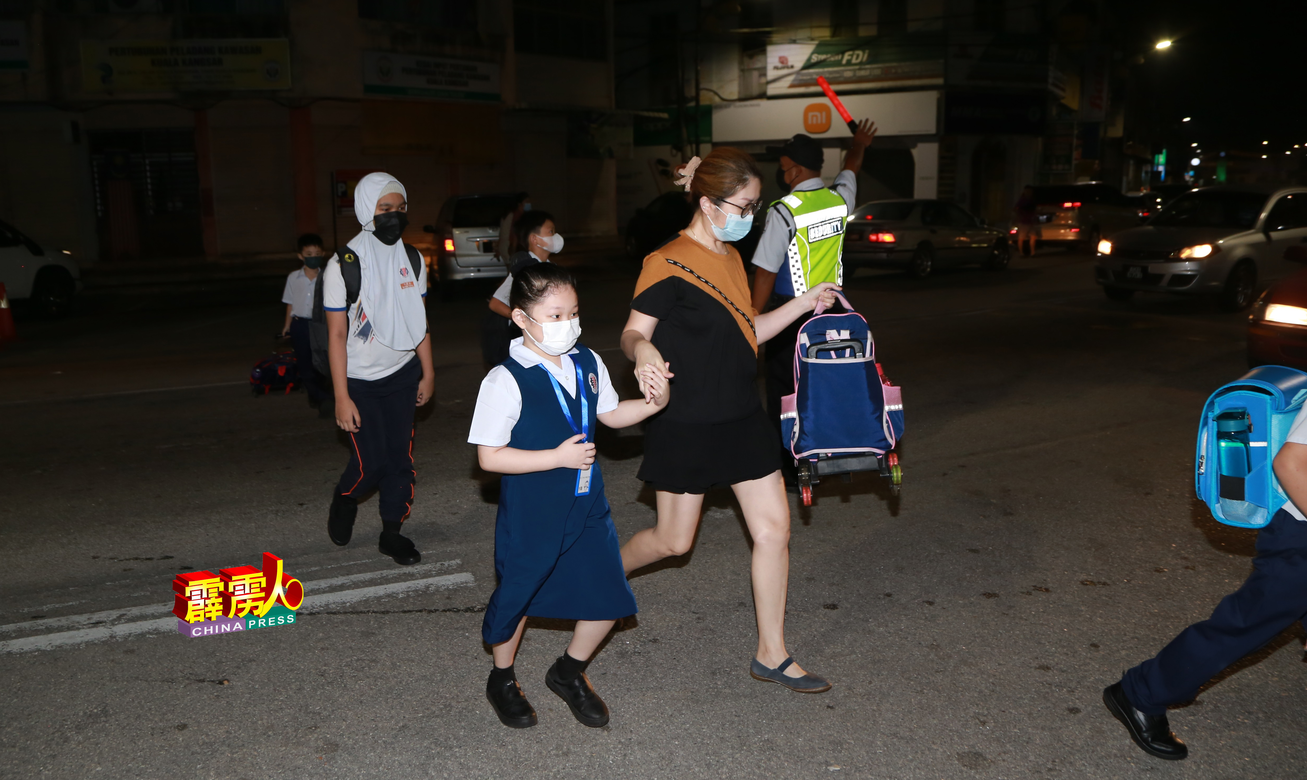 家长陆奕翠，清晨6时许带着女儿过马路上学。