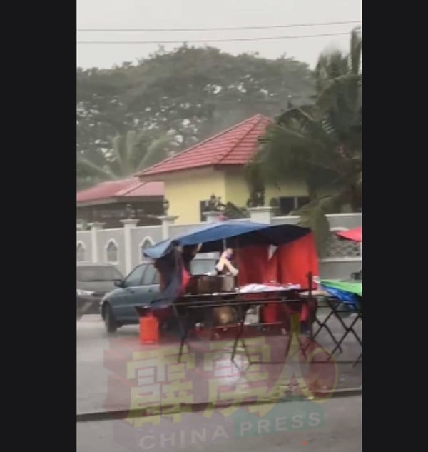5月4日下着大雨，熟食小贩来不及收摊，被逼淋雨。 （受访者提供）