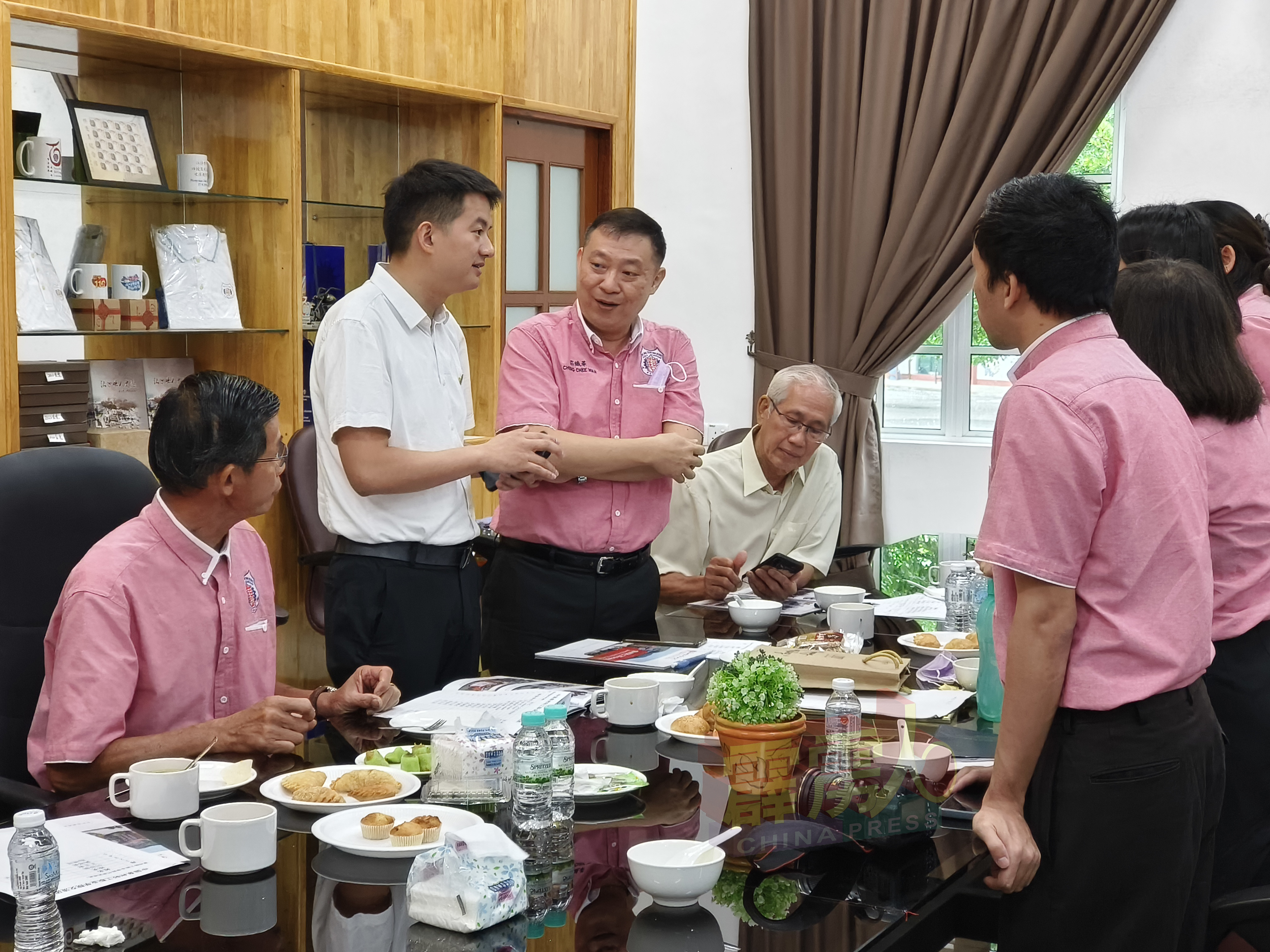 何振鹏（左2）与崇华独中董事及师长们，包括黄胜全（左）、庄校长（左3）及符儒惠等人交流甚欢。