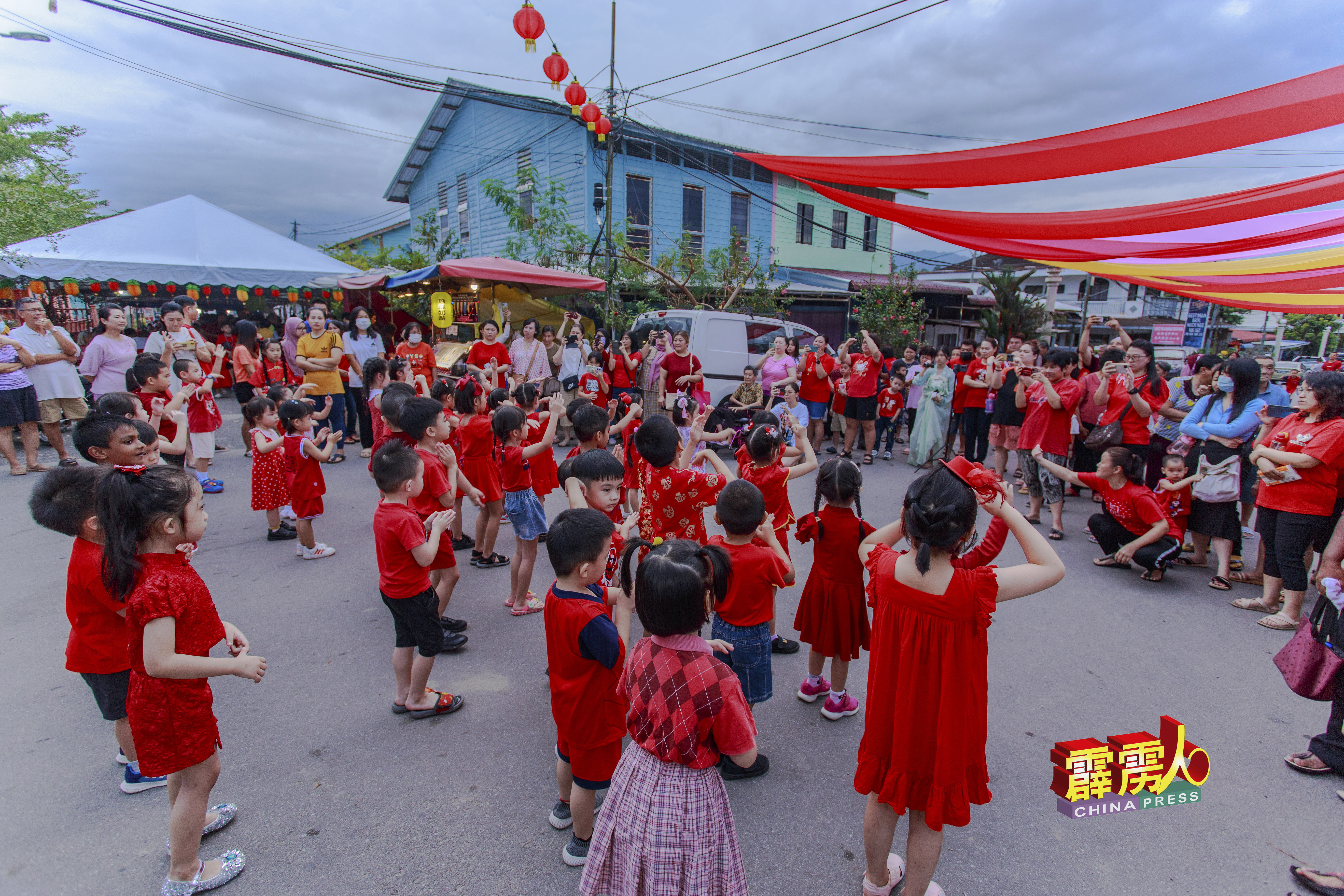 在园游会上安排MV拍摄，穿起红衣裳的小朋友们载歌载舞，落力配合拍摄。