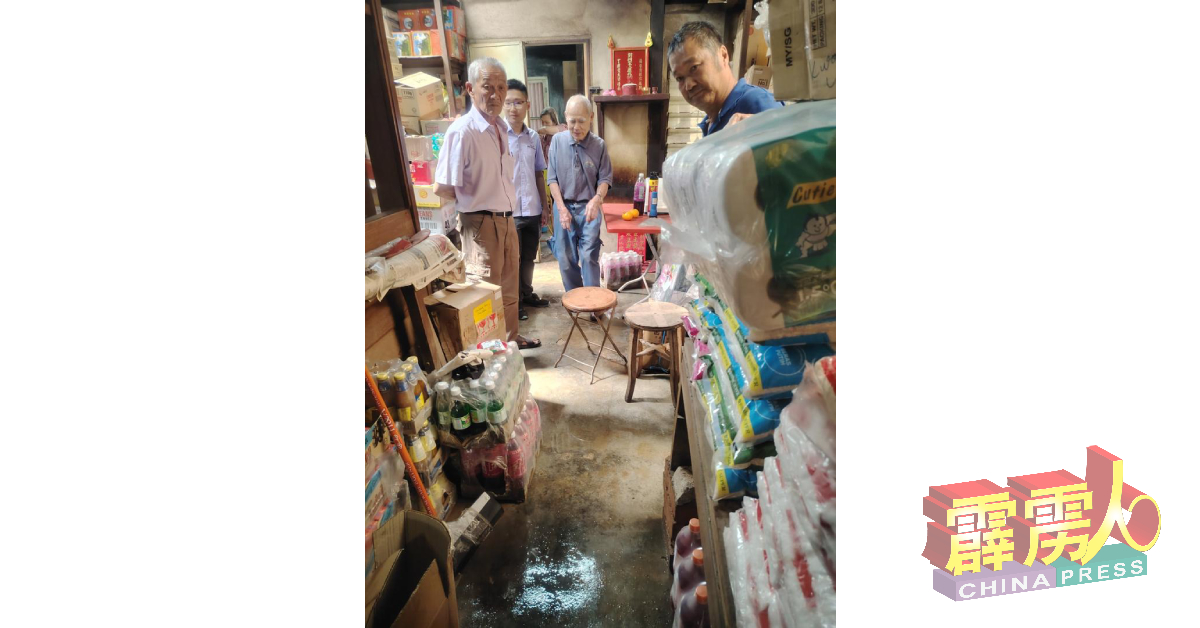 年迈夫妇经营的杂货店，也面对雨水淹进店里。