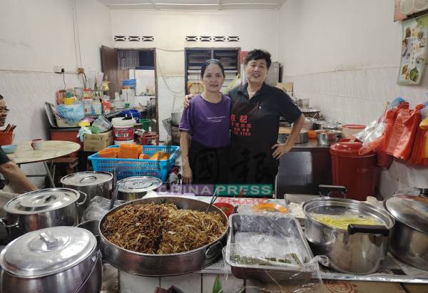 兰姐和女助手在摊位前合照。