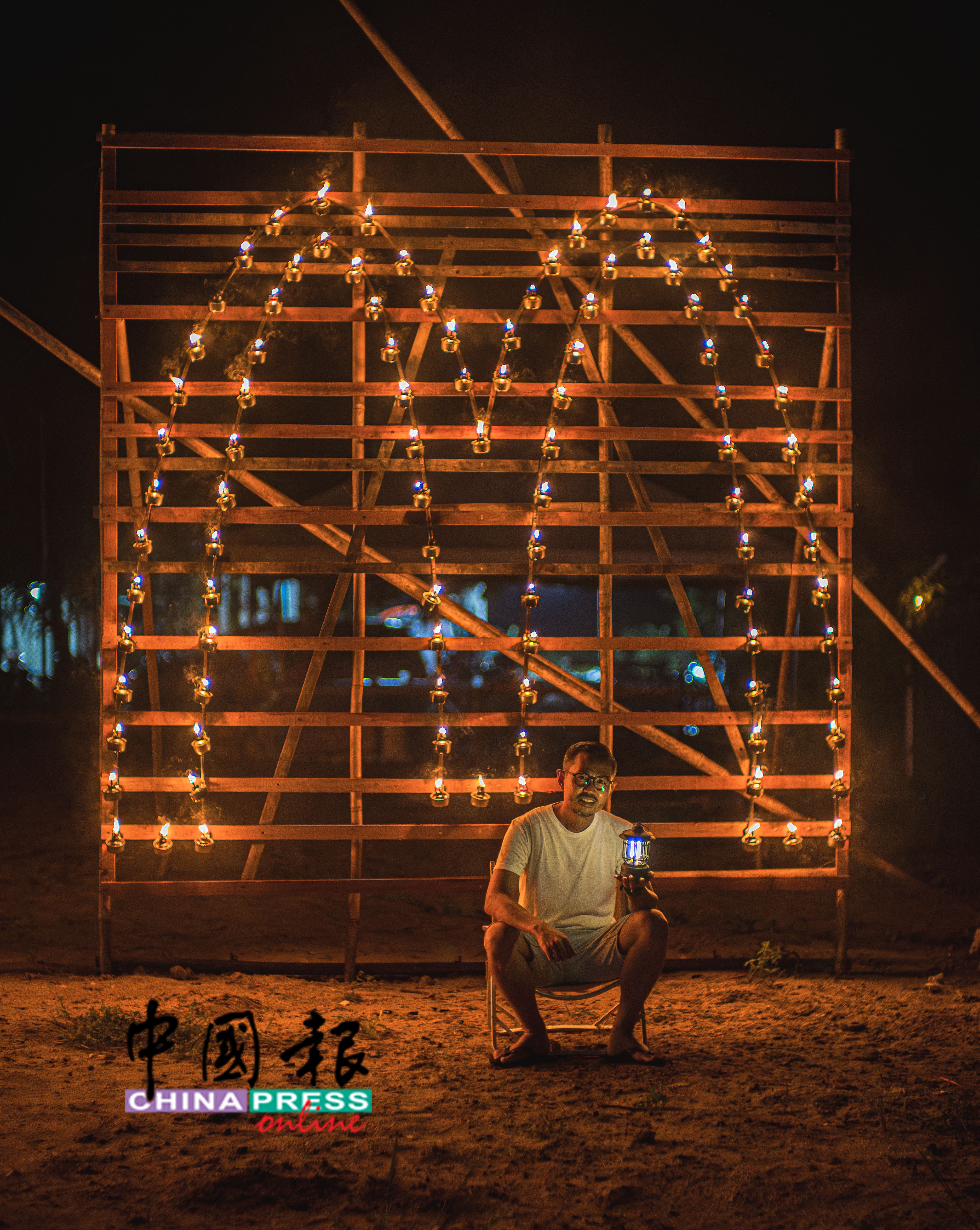 民众在大家熟悉的“M”字型土油灯框架前,打卡留念。