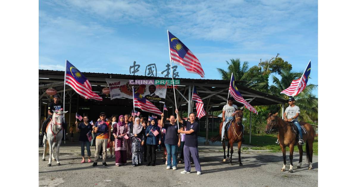 周承隆（前排右）为参与表演团体及游行队伍，主持挥旗礼；右3为诺哈雅蒂。