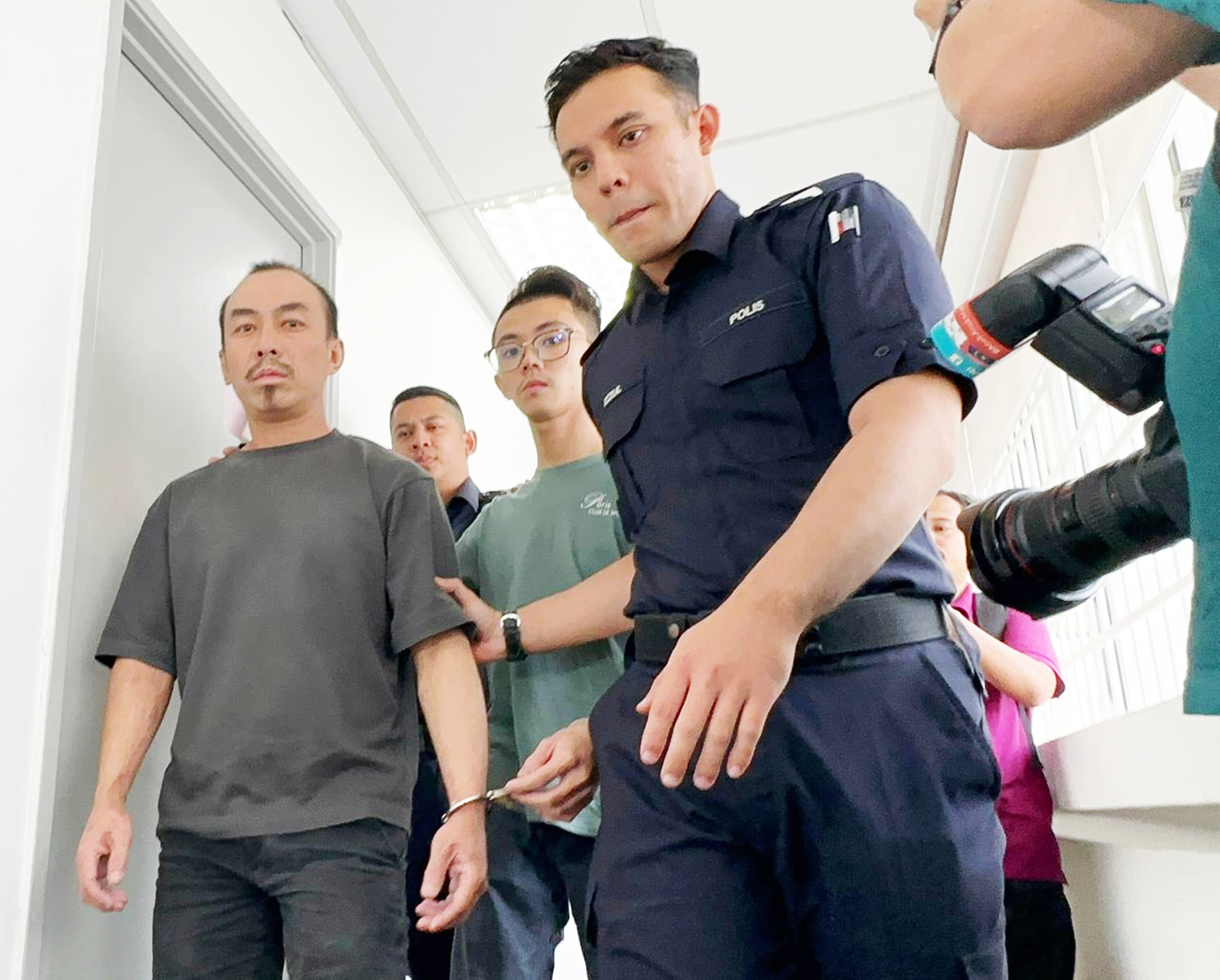 两名华裔男子冒警勒索少年案,周二双双被控上法庭时俯首认罪。